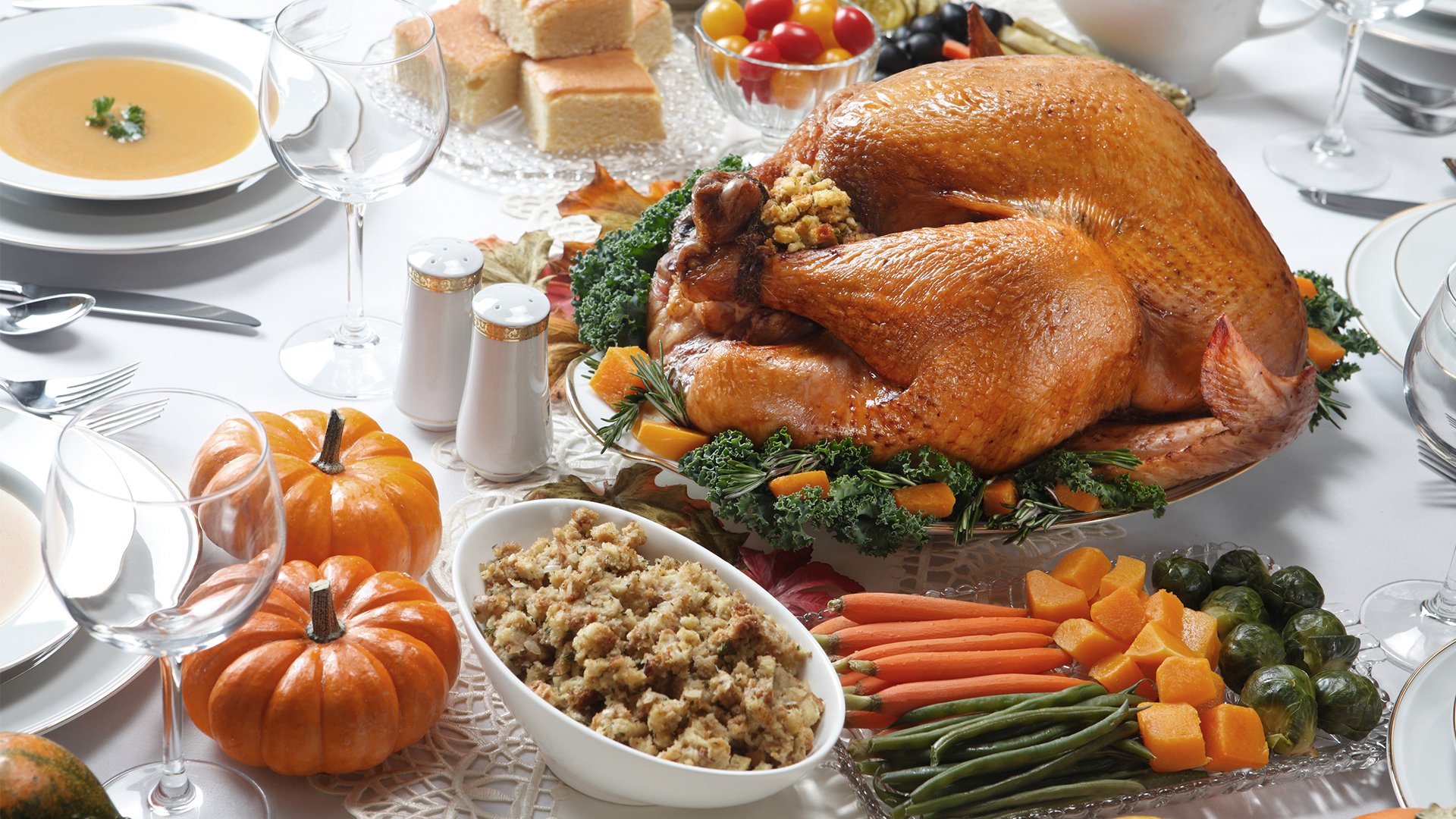 a turkey on a table with vegetables and fruits