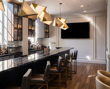 a kitchen with a bar and chairs