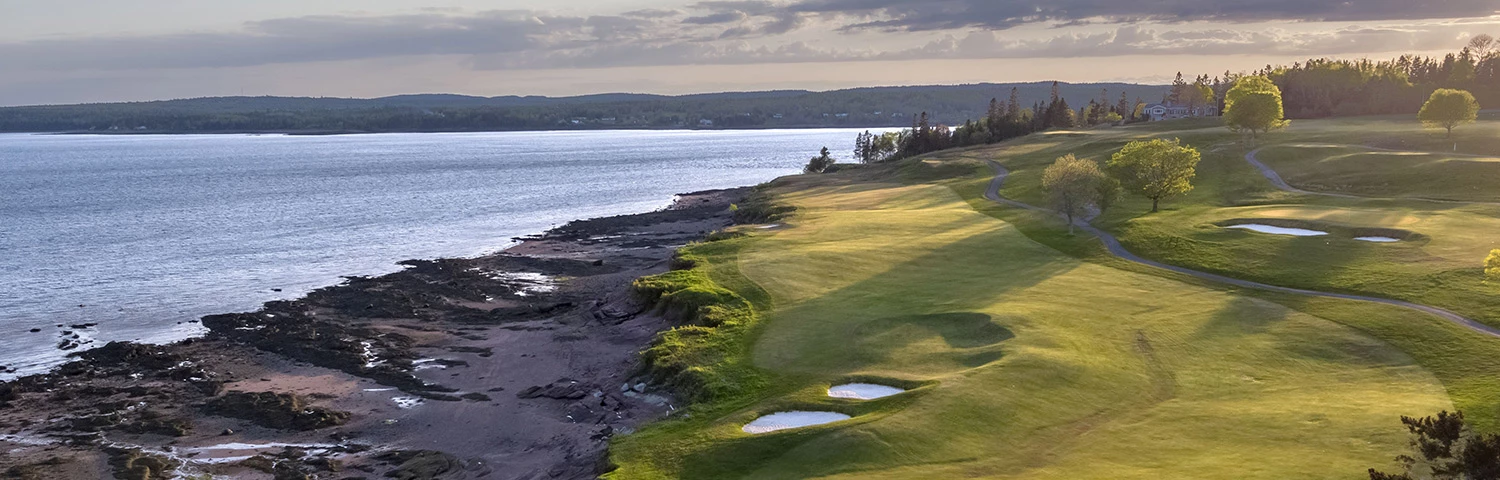 Green Golf course next to the ocean