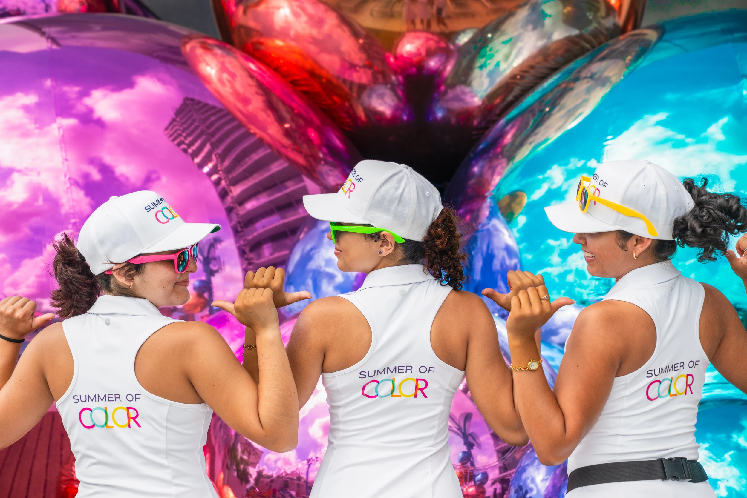 a group of women wearing white shirts and hats