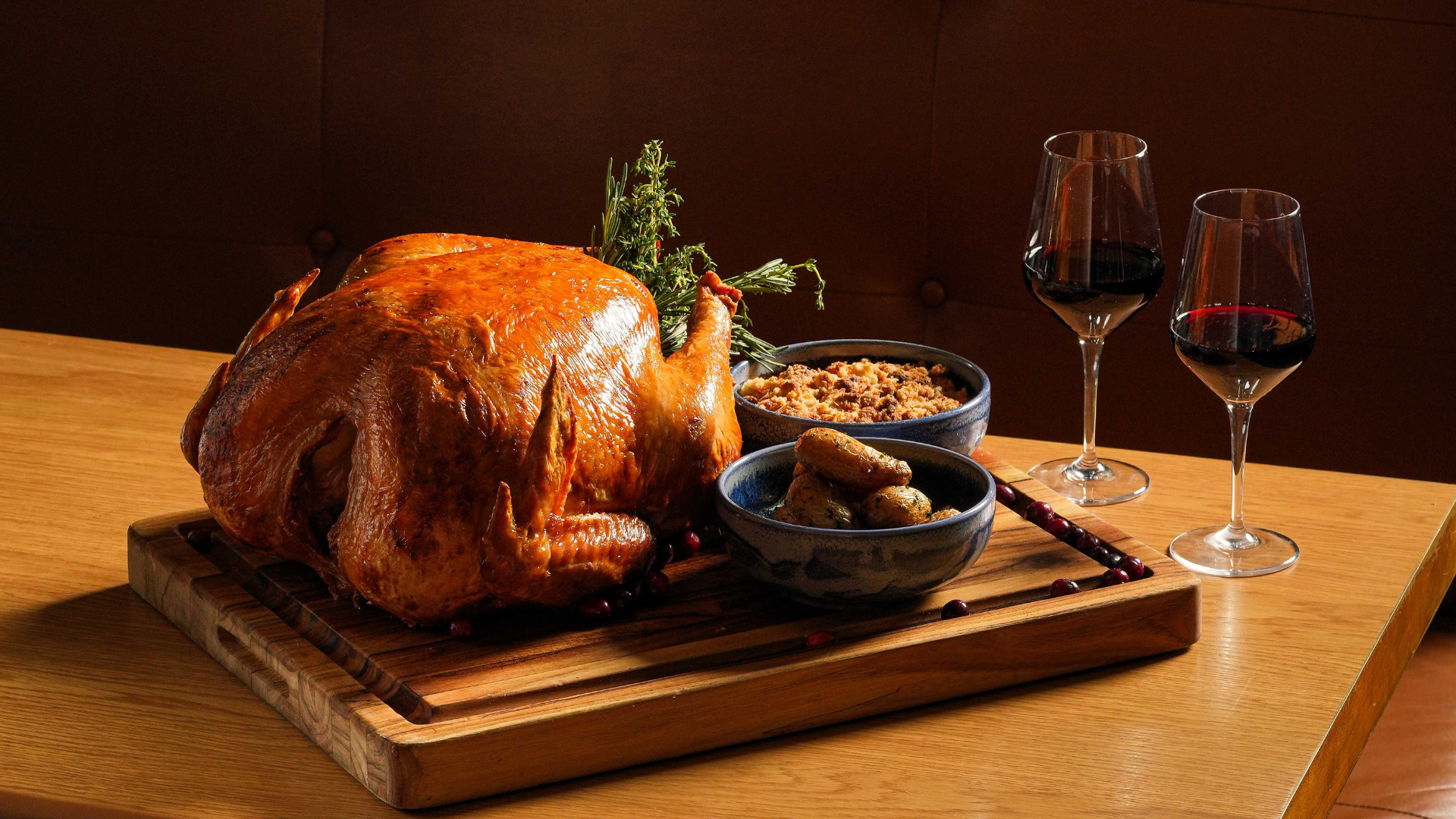 a turkey and bowls of food on a wooden board
