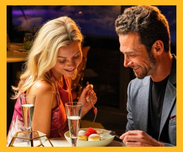 a man and woman eating dessert