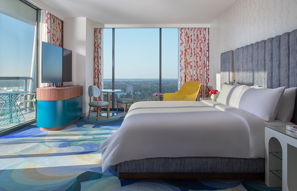 a room with a bed and a television