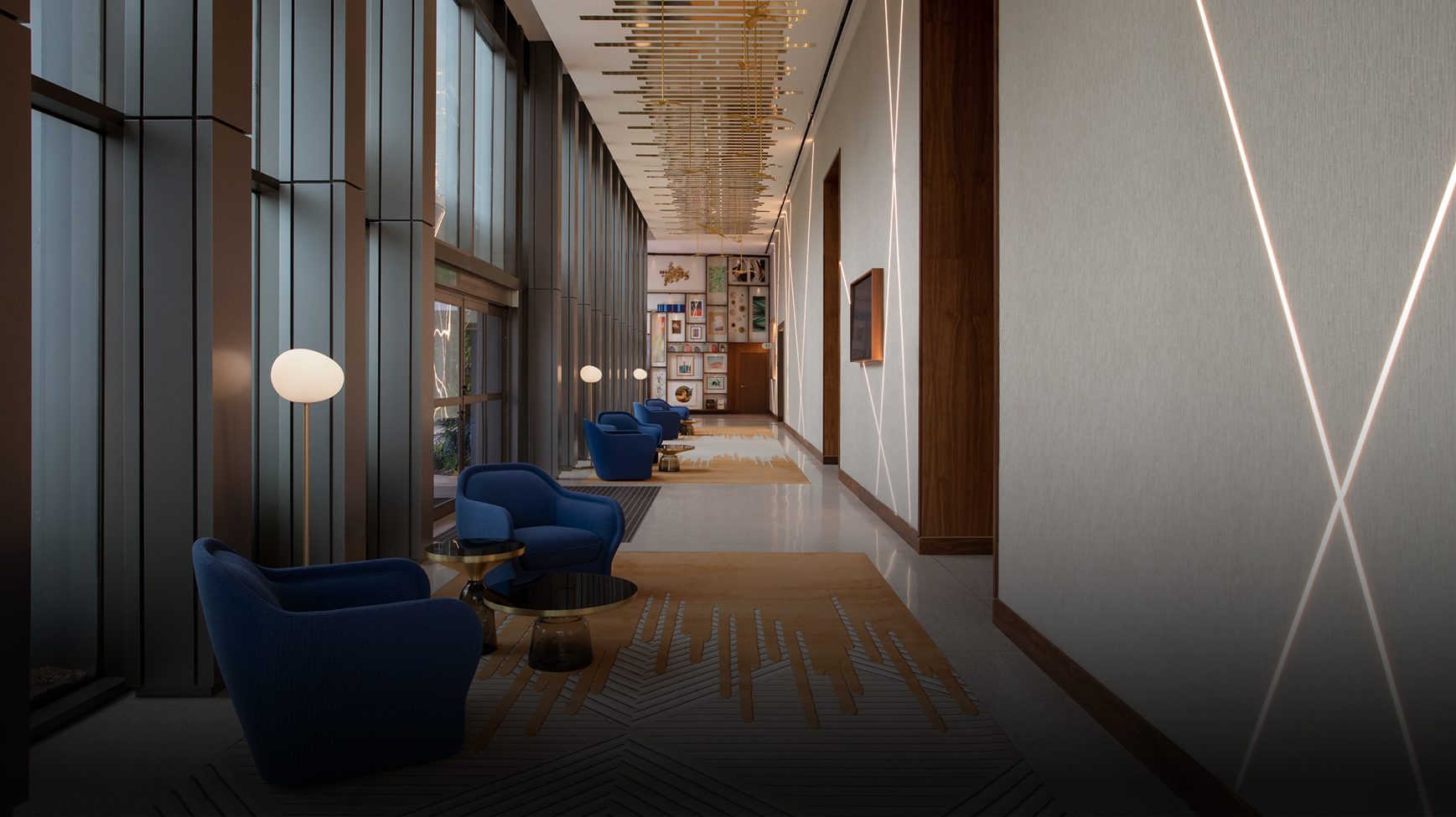 a long hallway with blue chairs and a lamp