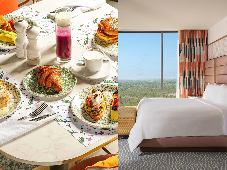 a breakfast table with food on plates and a bed