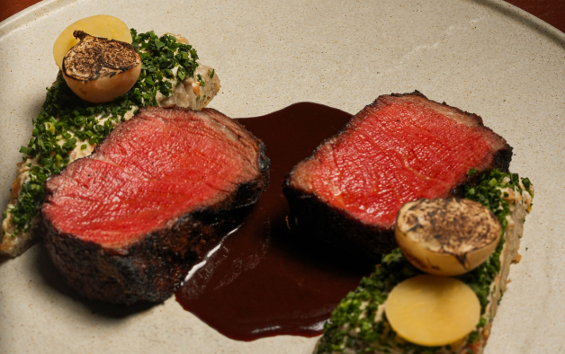 a steak with sauce on top of it