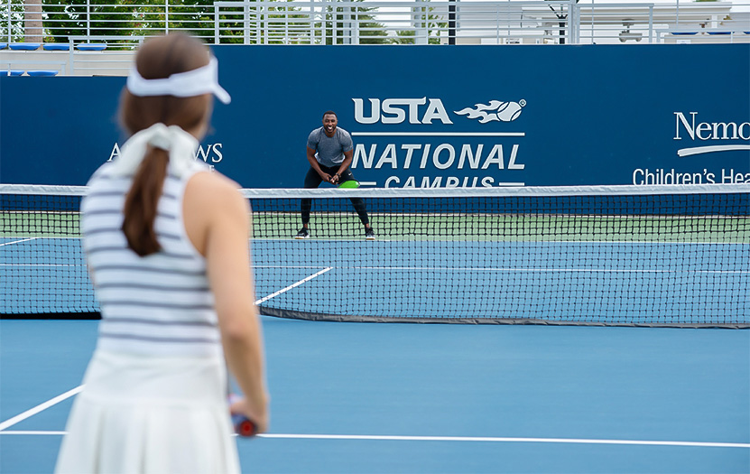 a man and woman on a tennis court