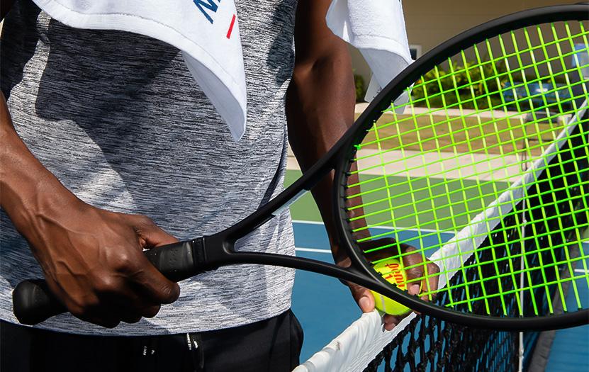a man holding a tennis racket