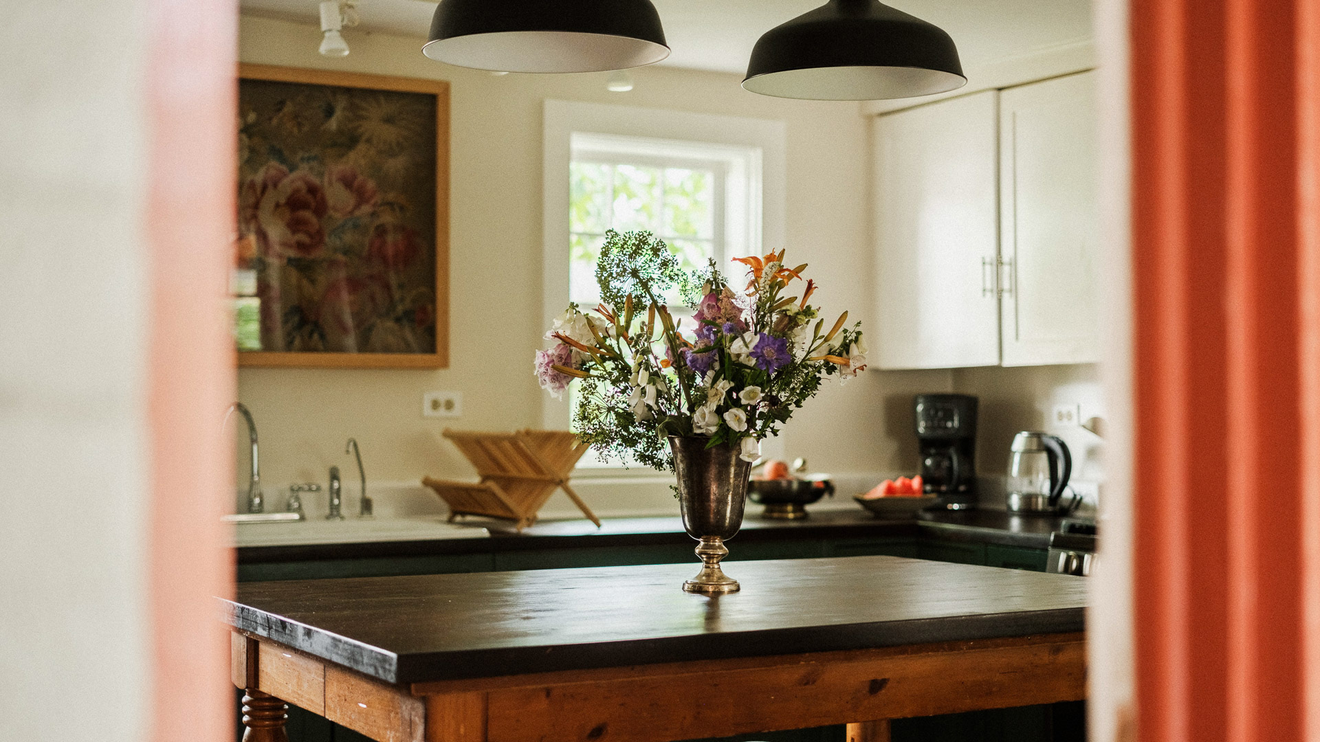 a vase of flowers on a table in a kitchen