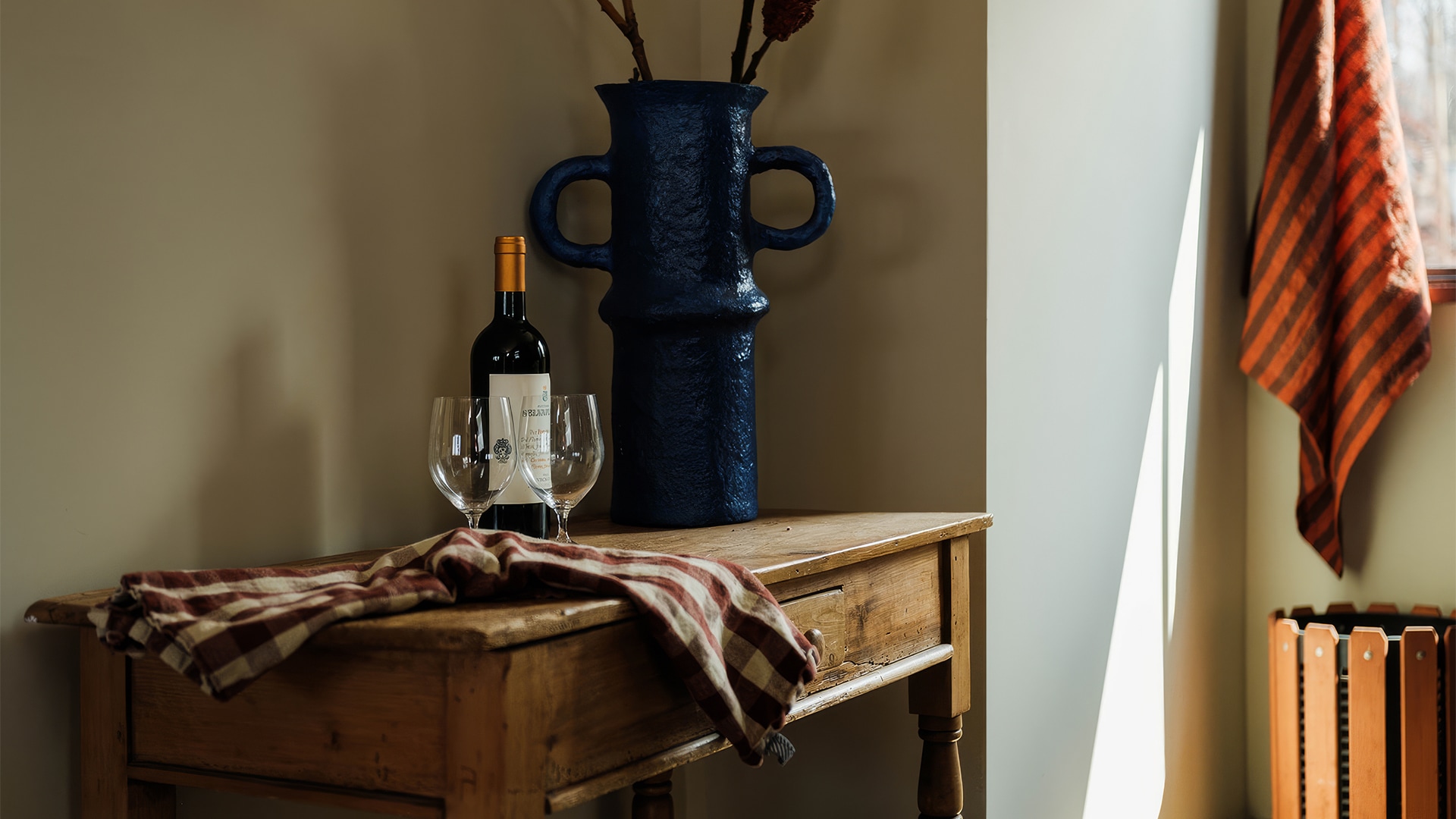 a wine bottle and wine glasses on a table