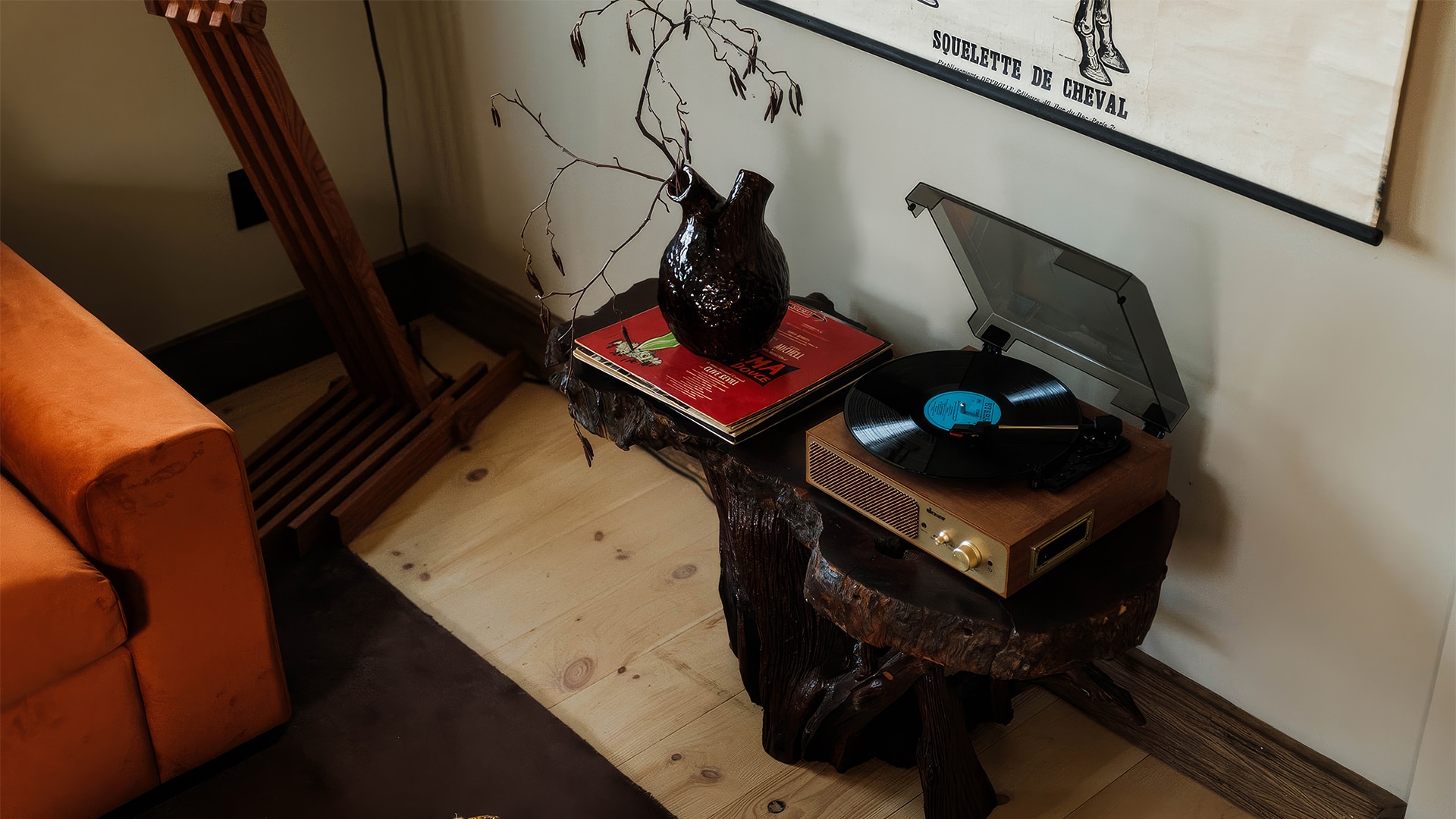 a table with a record player and a vase on top