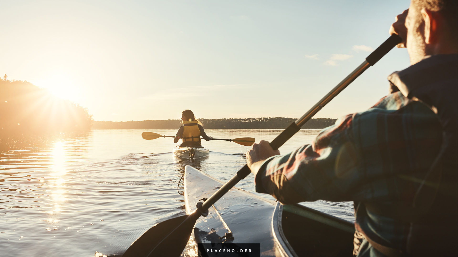a person in a canoe with paddles on the water