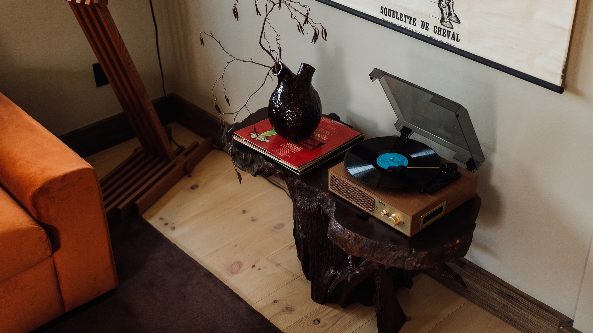 a table with a record player and a vase on it