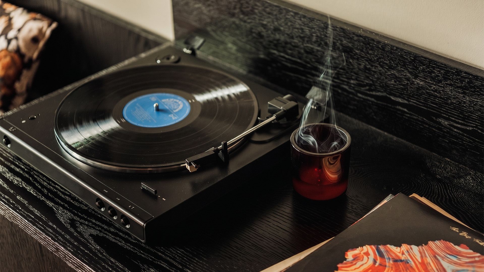 a record player with a cup of smoke