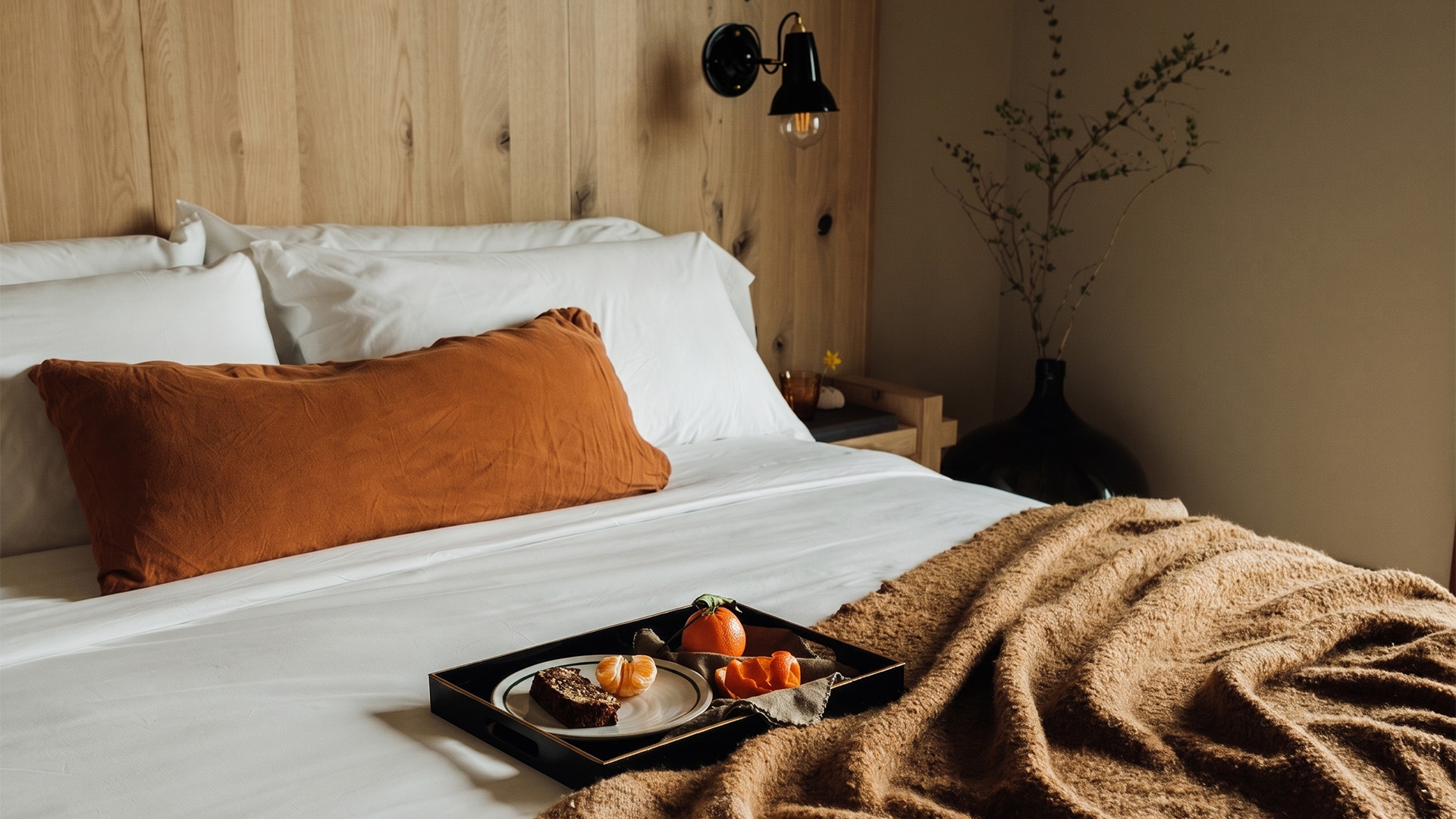 a tray of food on a bed