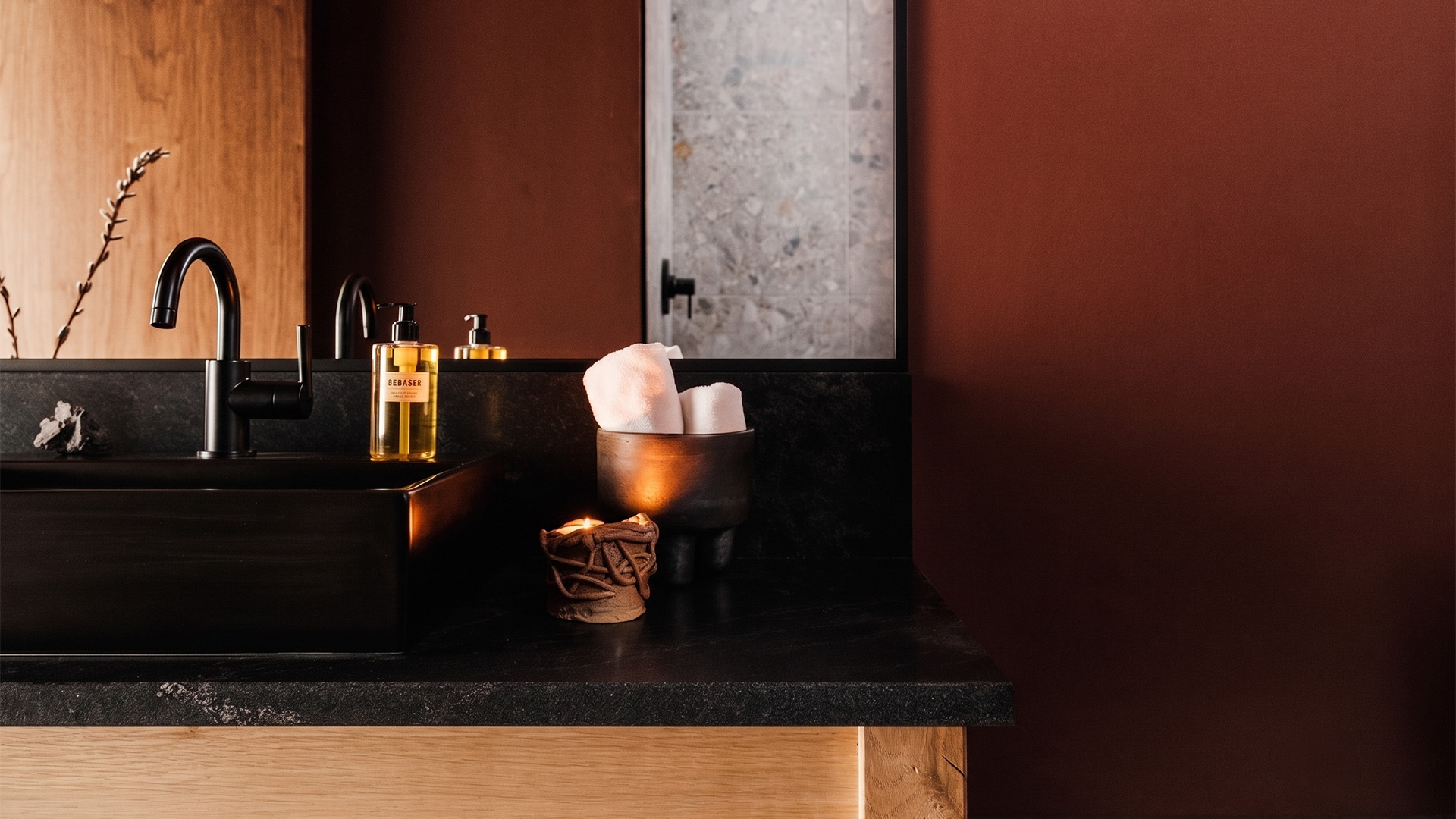 a bathroom sink with a candle and a bowl of cotton on it