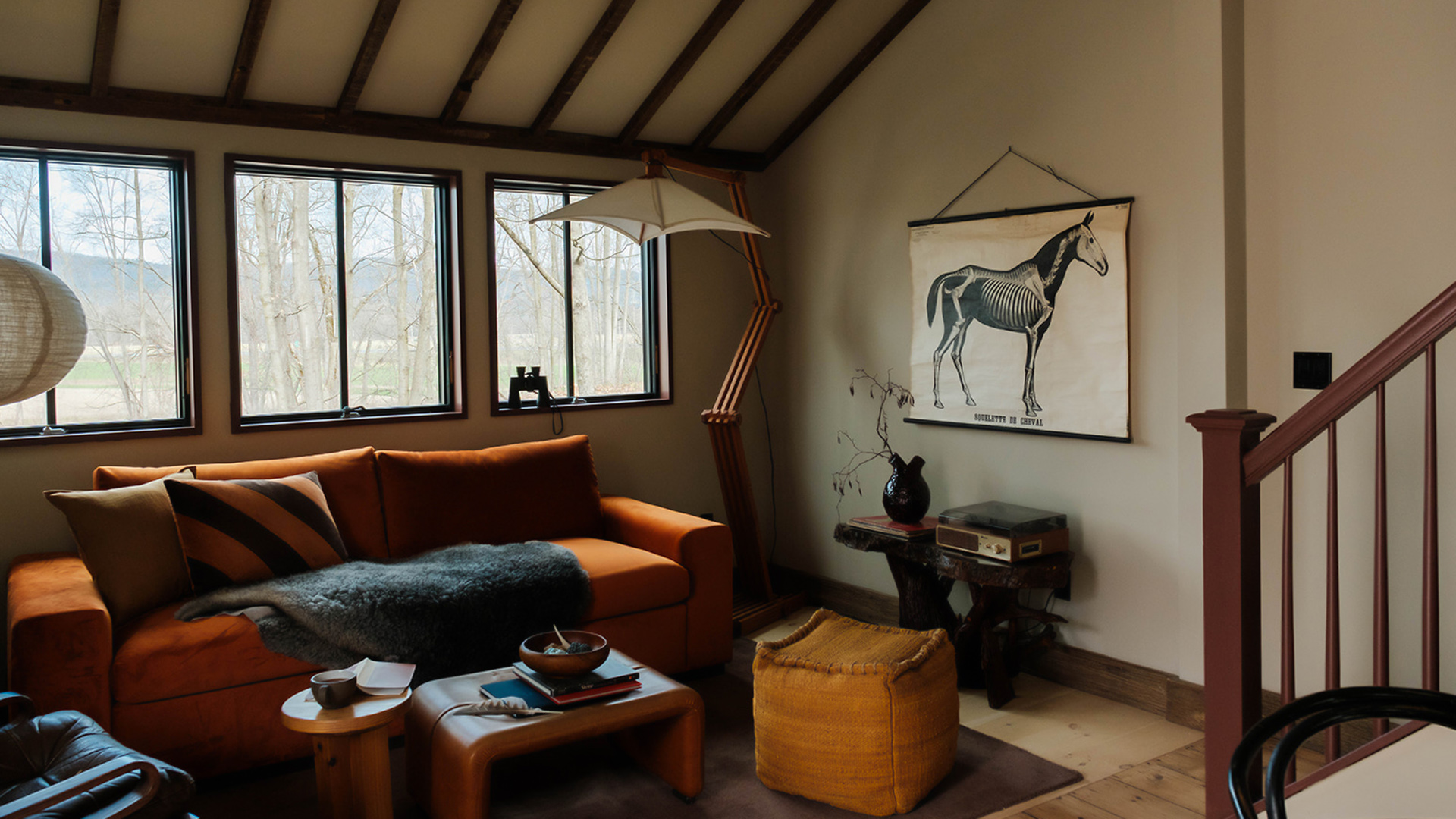 a room with a couch and a poster on the wall