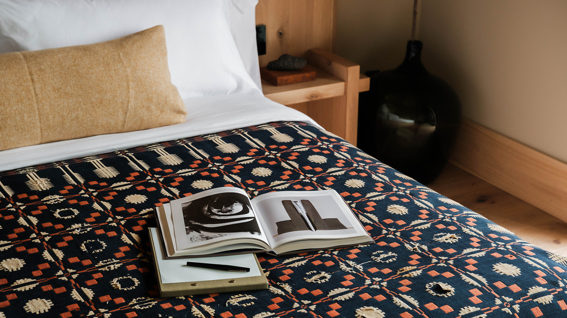 a book and pen on a bed