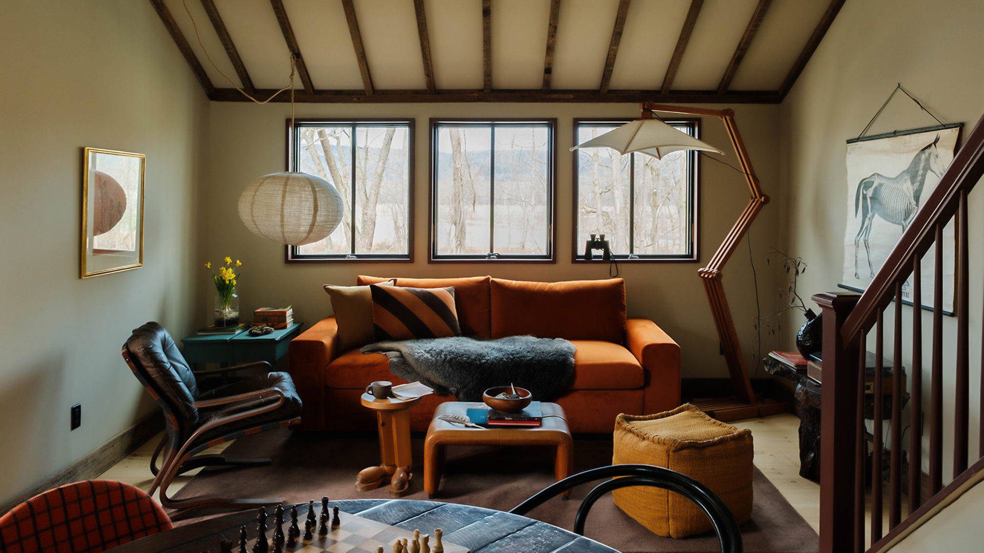 a living room with a couch and chess board