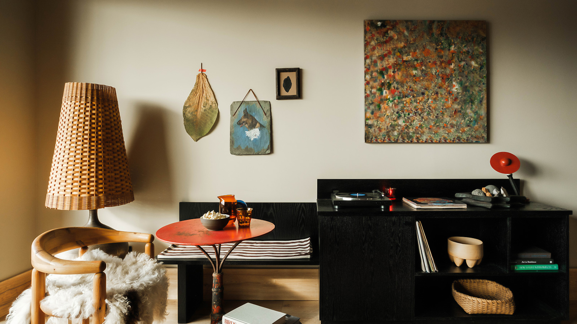 a room with a table and a painting on the wall