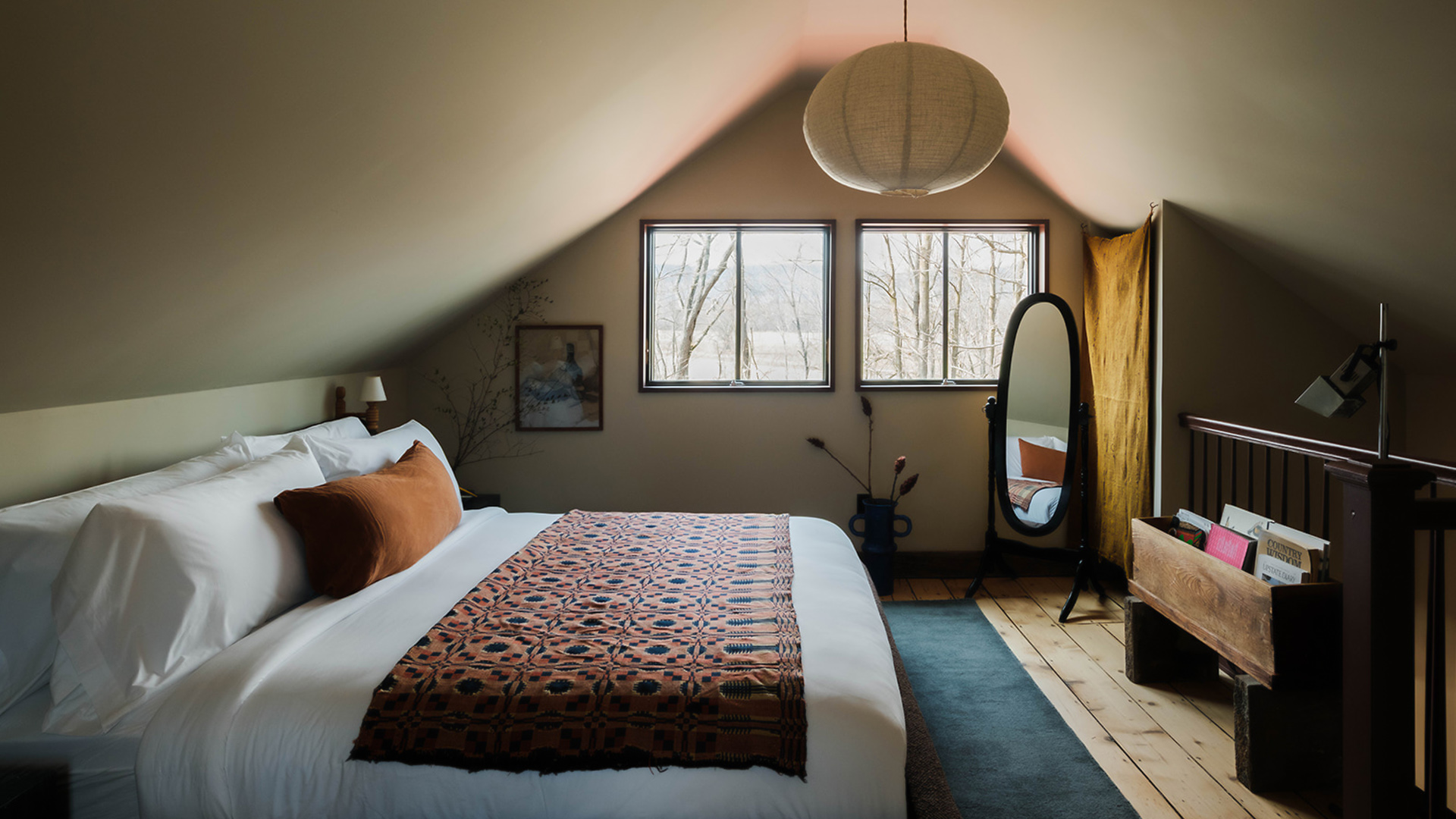 a bedroom with a mirror and a bed