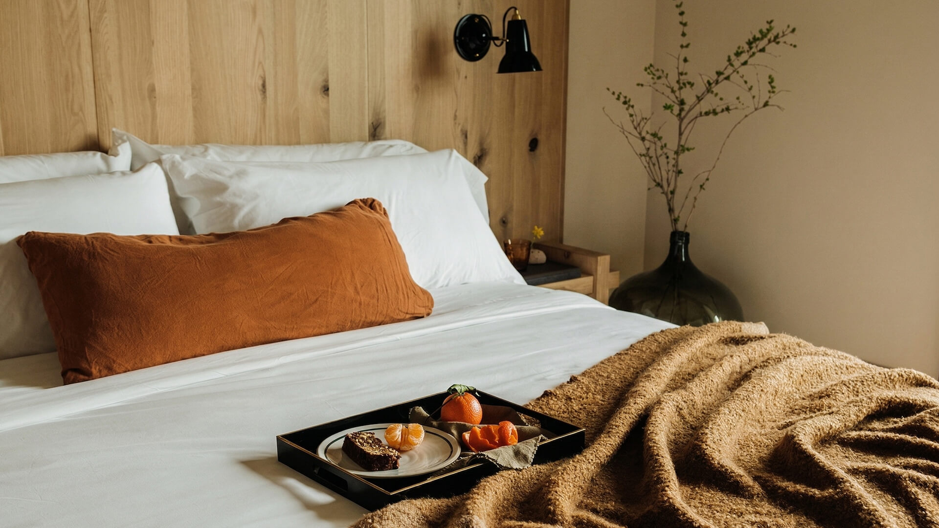 a tray of food on a bed