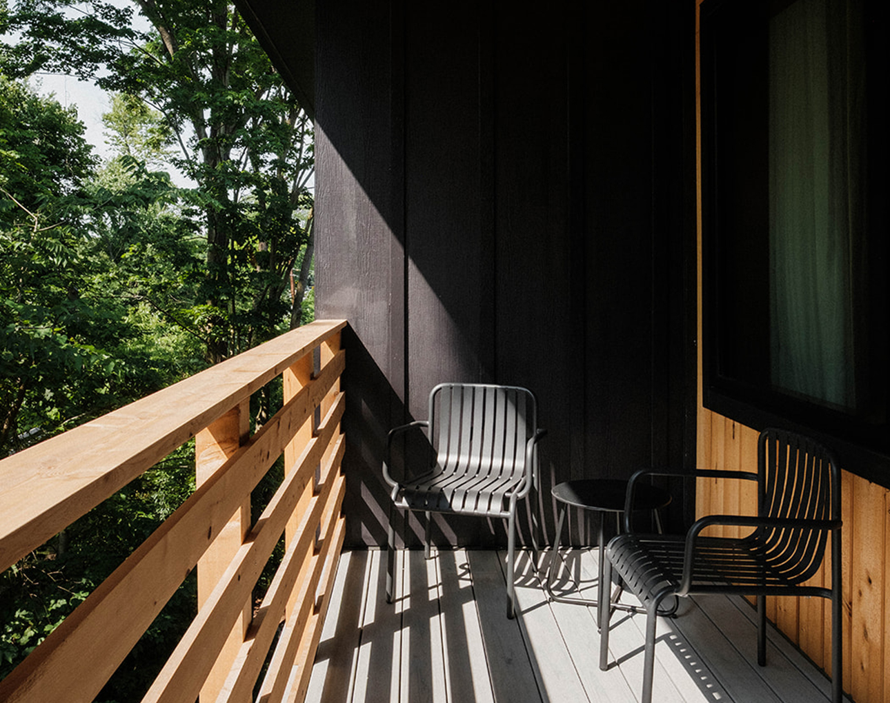 chairs on a deck with a railing