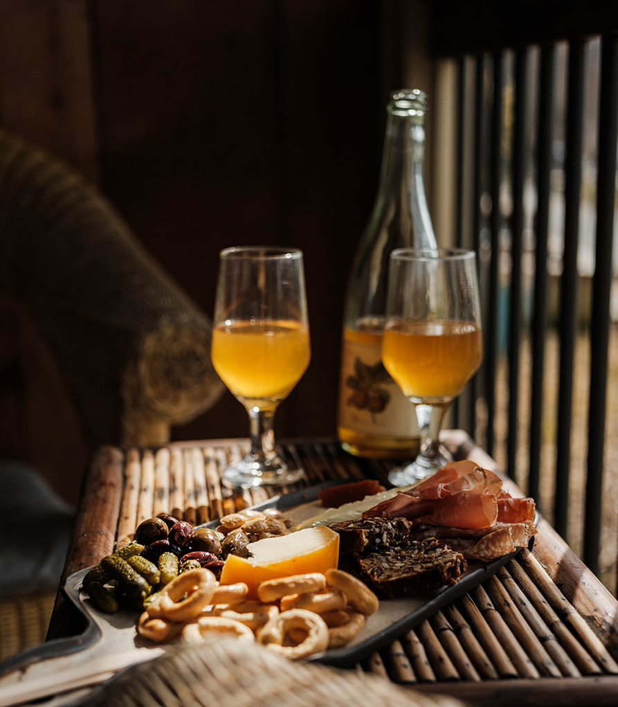 a tray of food and glasses of beer on a table