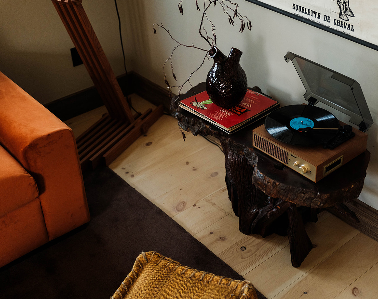 a record player and vase on a table