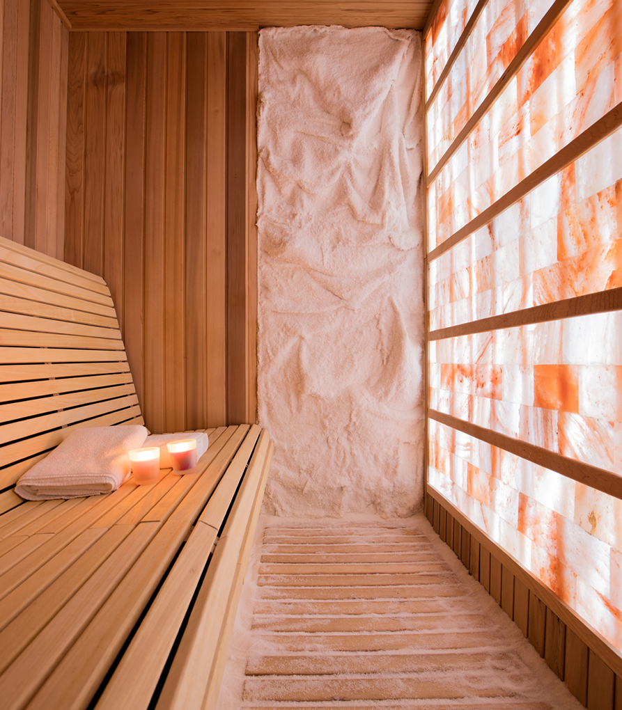 a wooden bench with candles and salt in the back