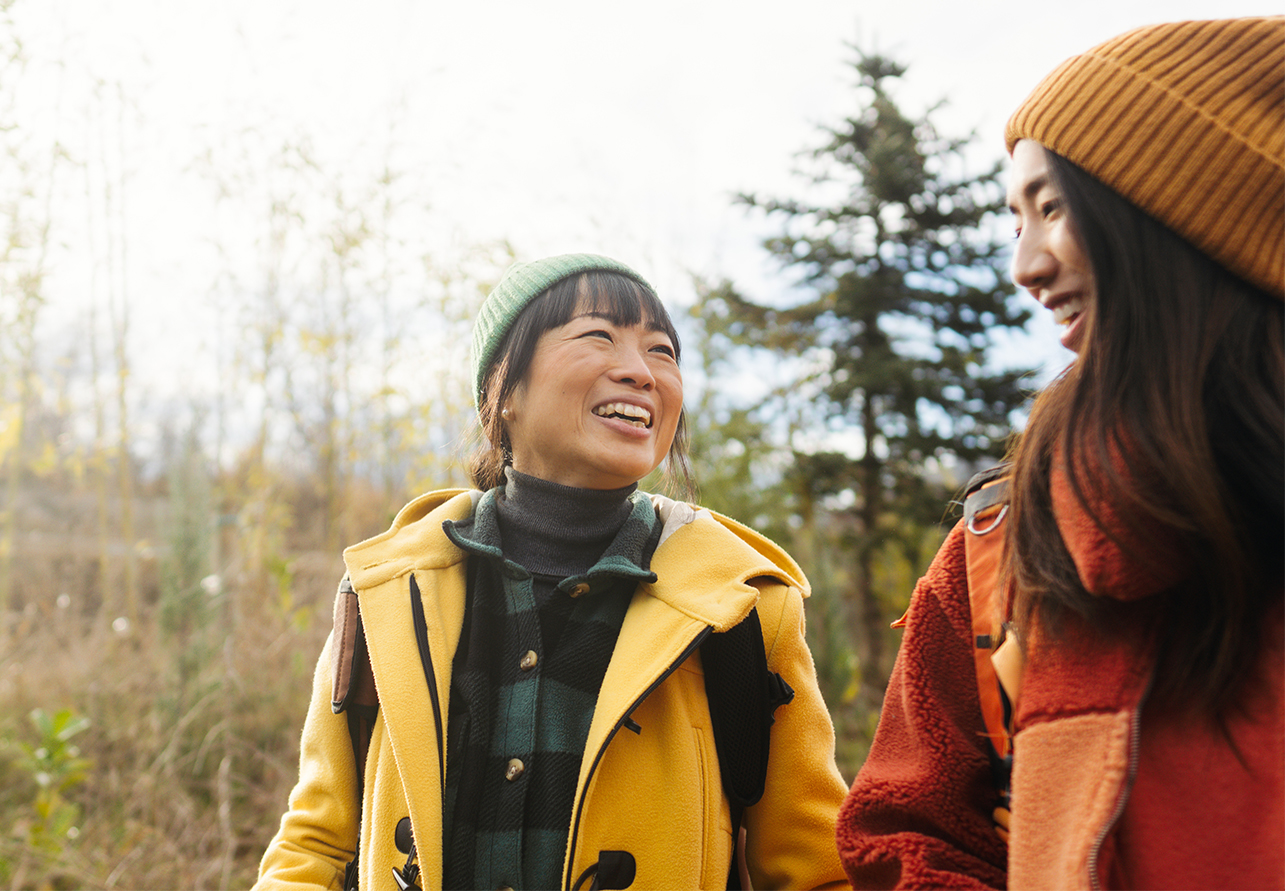 a group of women smiling and looking at each other