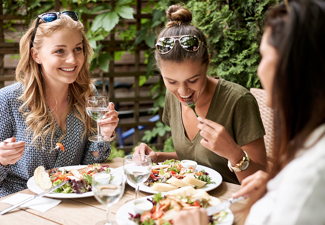 a group of women eating at a table