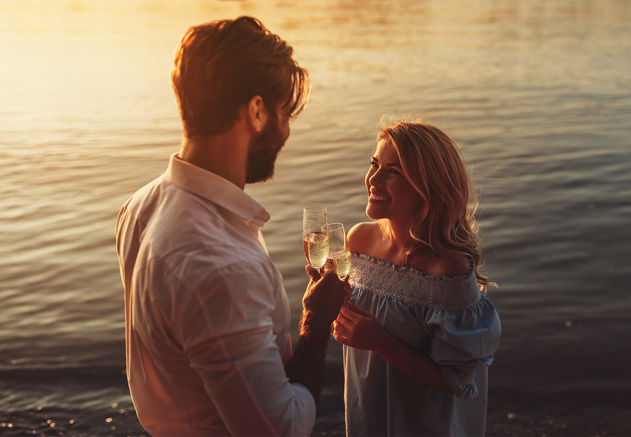 a man and woman holding champagne glasses
