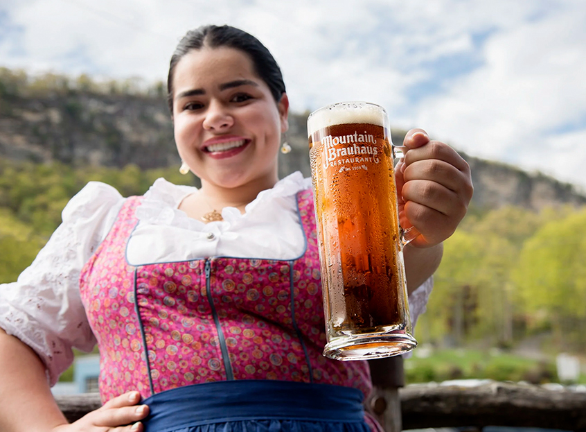 a woman holding a glass of beer