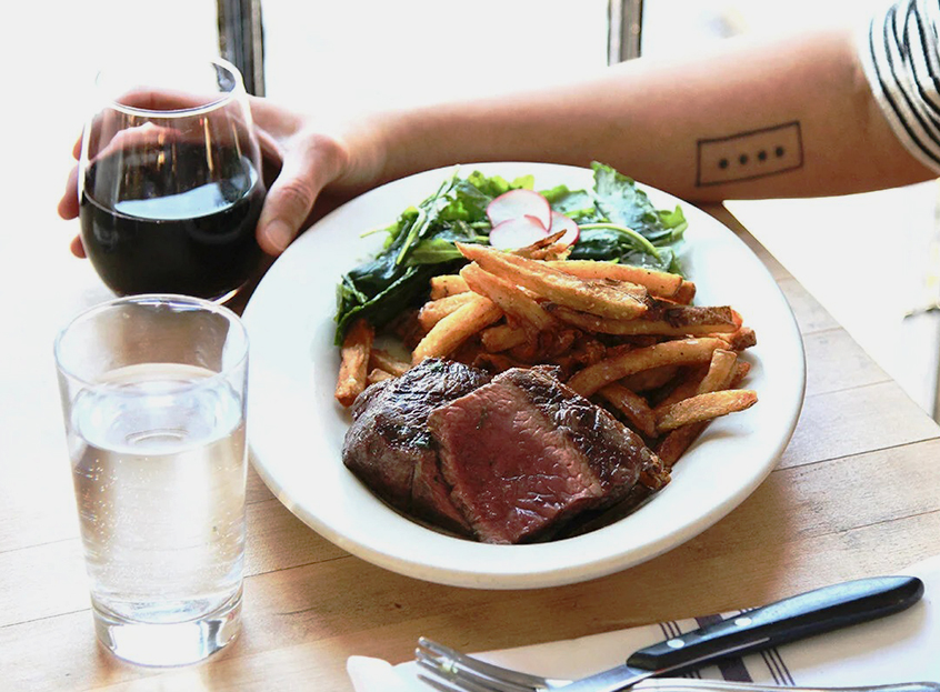 a plate of food and a glass of wine
