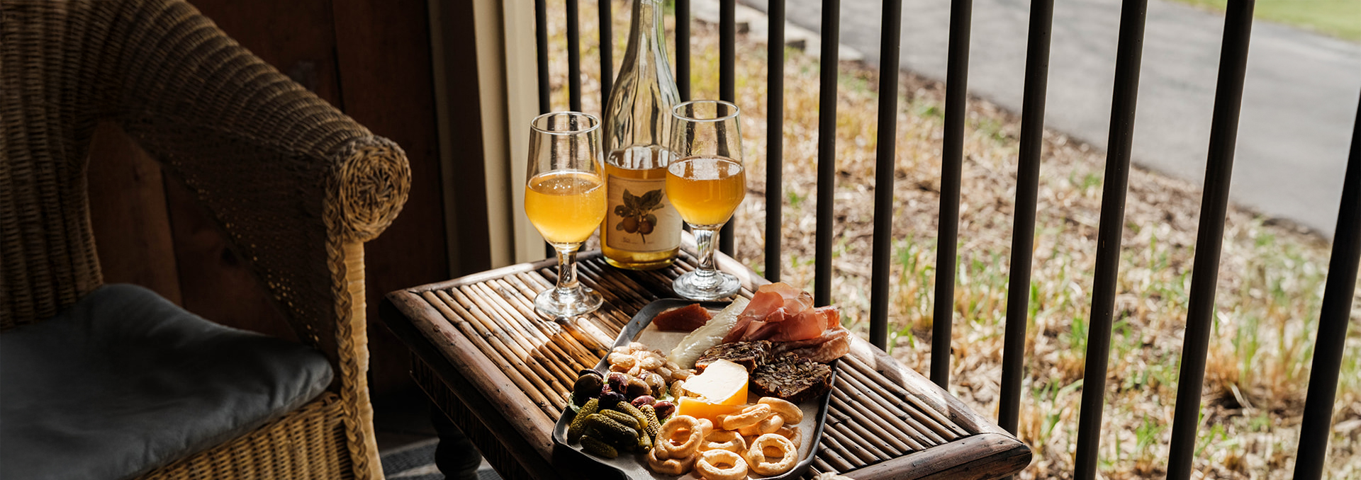 a plate of food and glasses of wine on a table