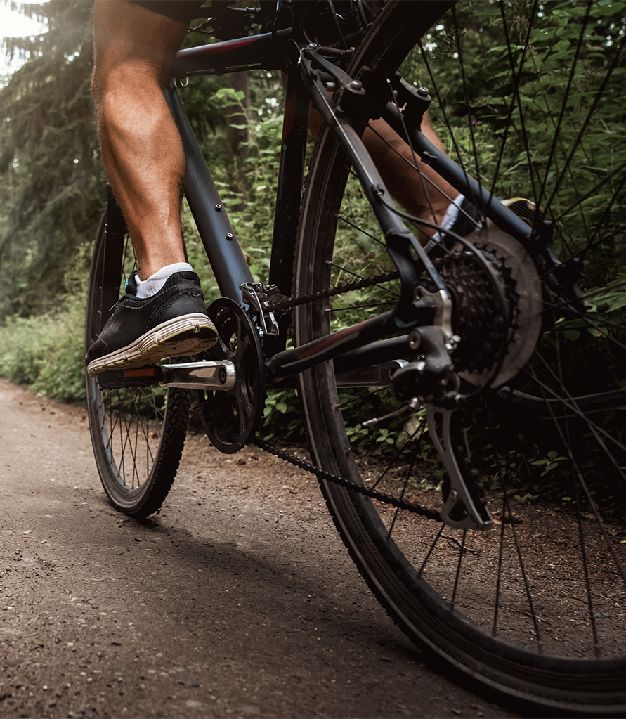 a person's legs on a bicycle