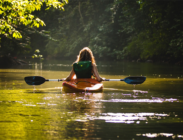 a woman in a kayak on a river