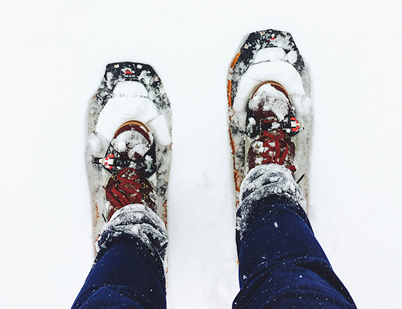 a person's feet in snowshoes