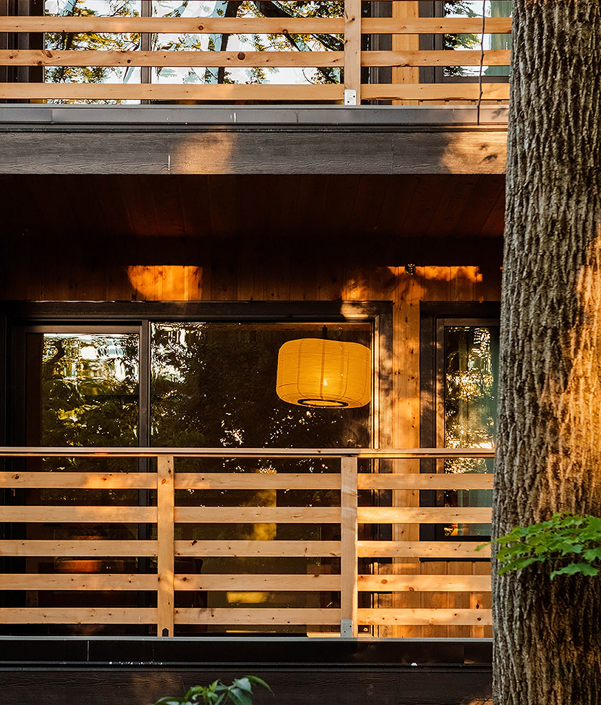 a wooden house with a lamp