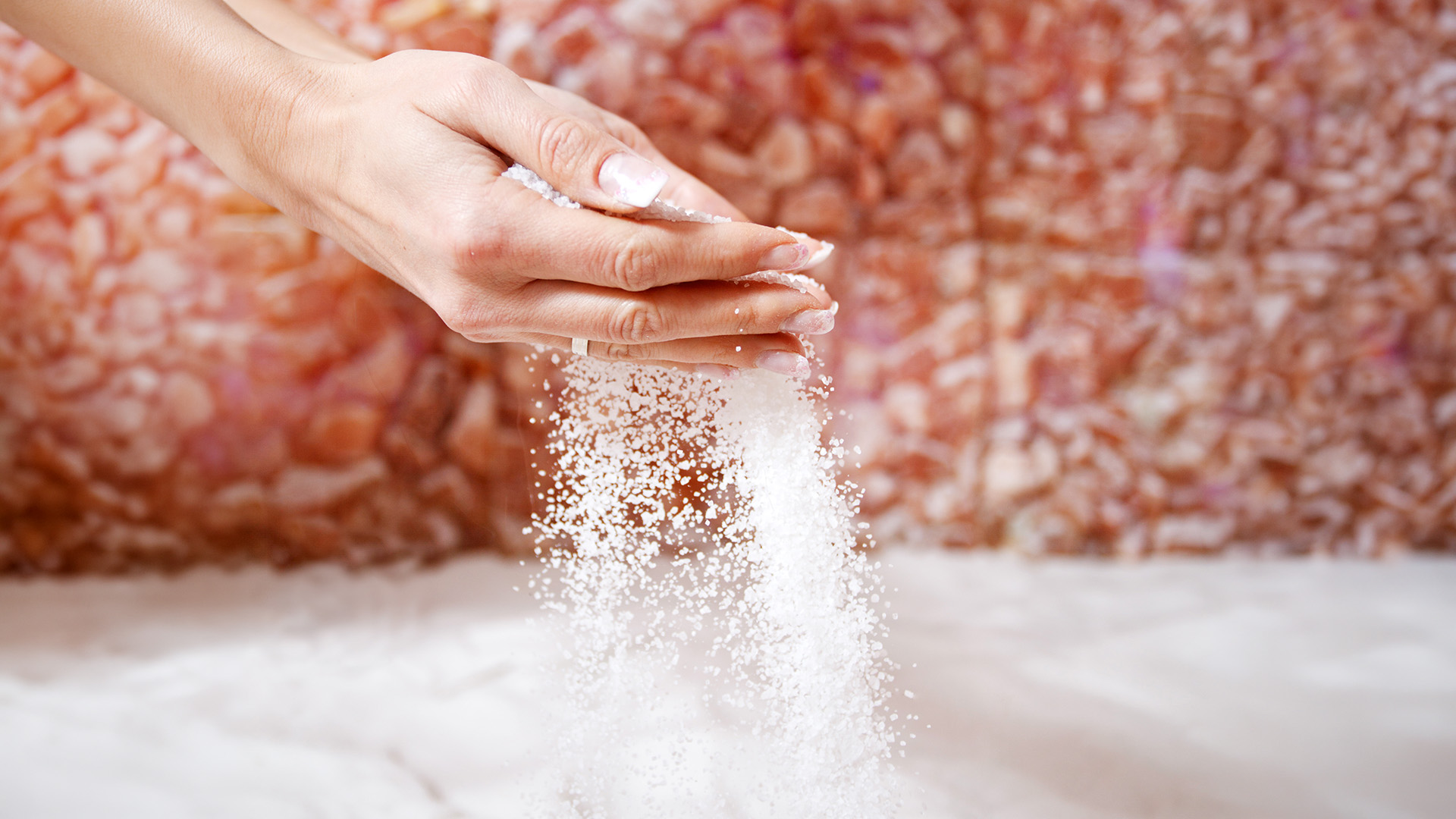 a person pouring salt into their hands