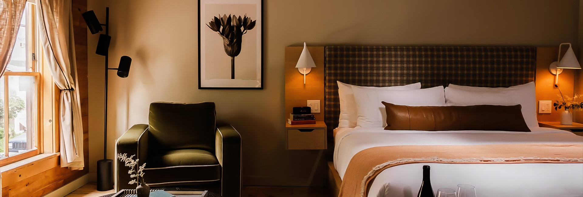 a bed with a lamp and a picture on the wall