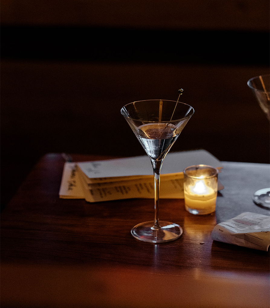 a martini glass with a olive in it