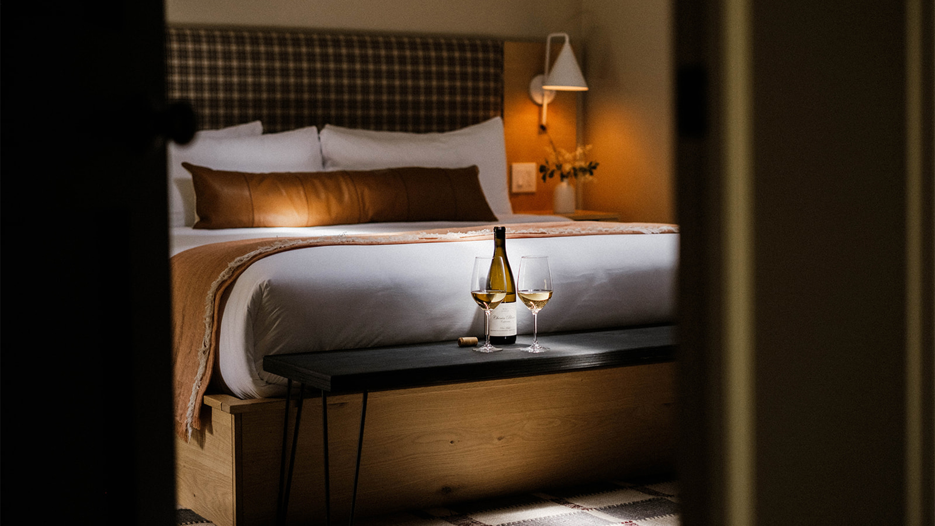 a glass of wine on a bed