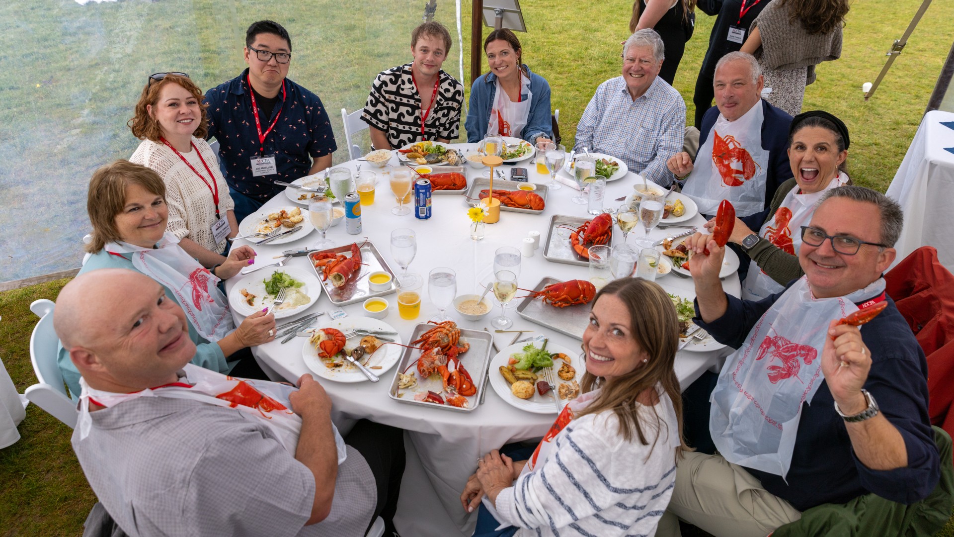 a group of people sitting around a table with food