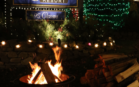 a fire pit with a fire in front of a sign
