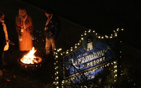 a group of people standing around a fire