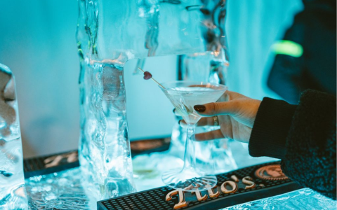 a hand holding a martini glass