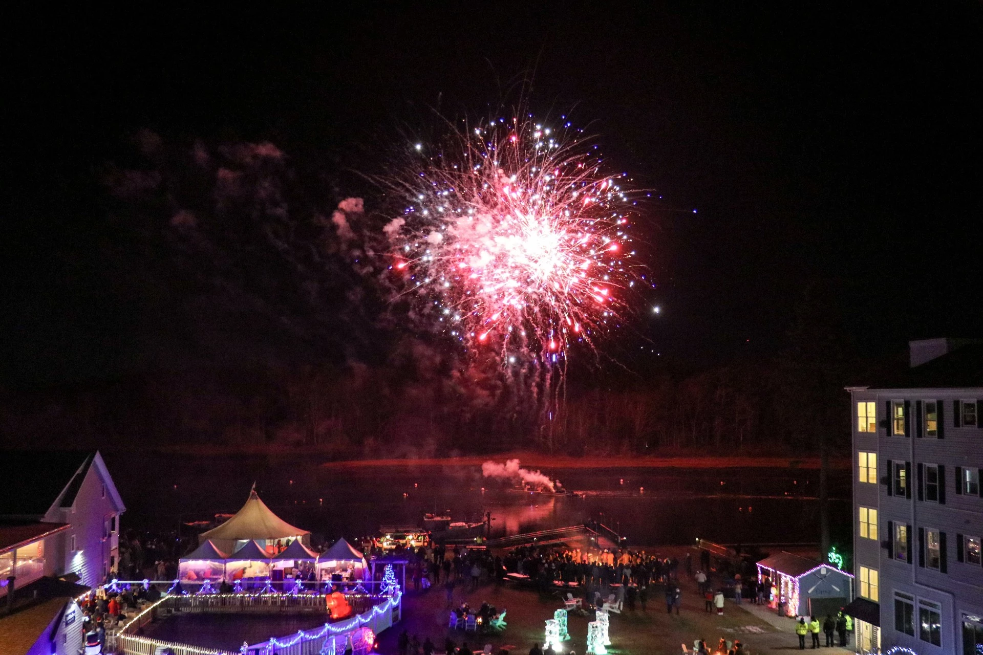 fireworks in the sky over a lake