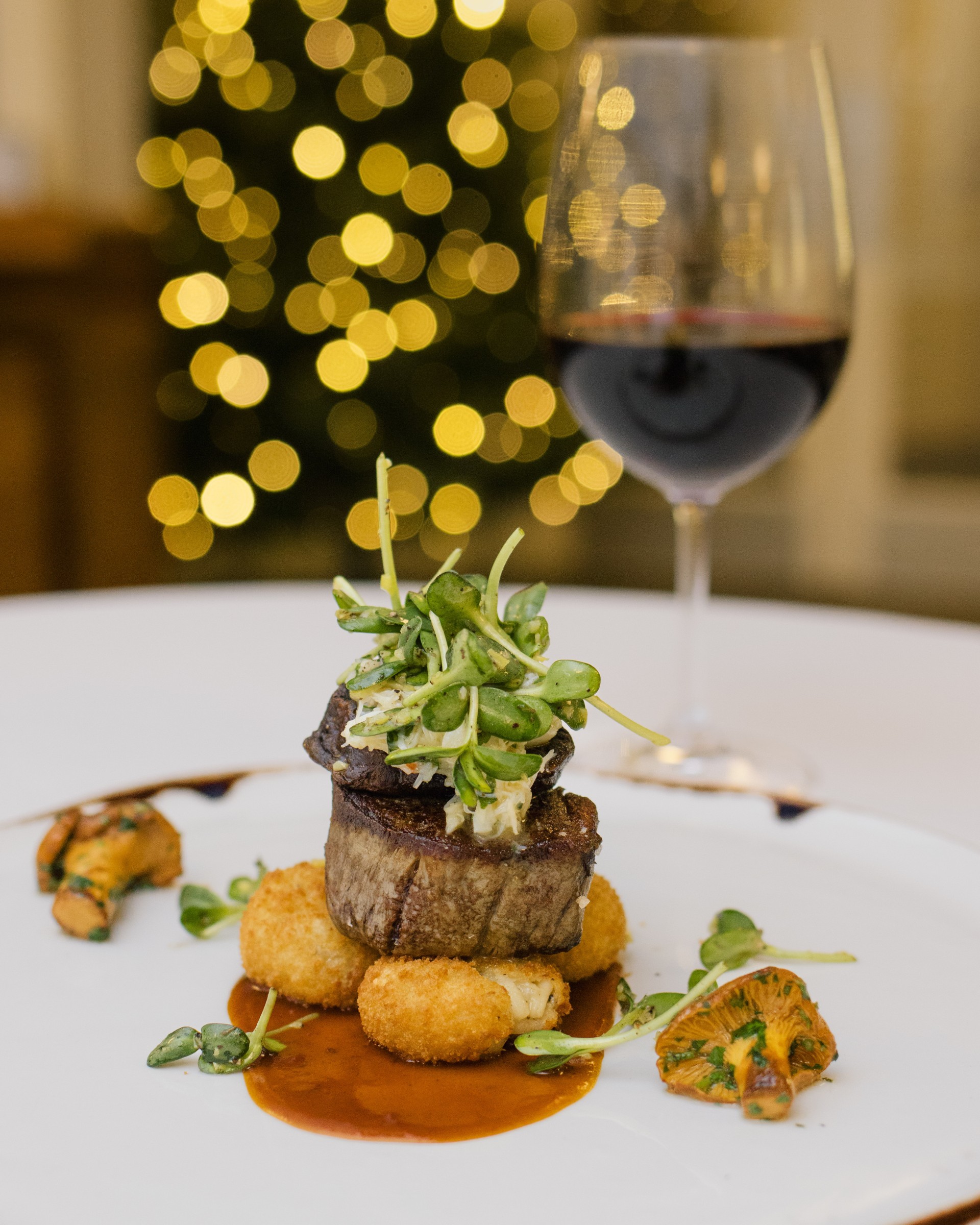 a plate of food and a glass of wine